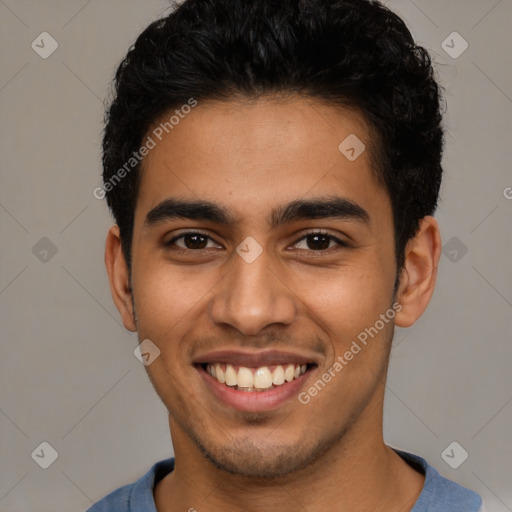 Joyful latino young-adult male with short  brown hair and brown eyes