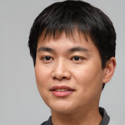 Joyful asian young-adult male with short  brown hair and brown eyes