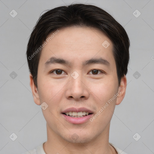 Joyful asian young-adult male with short  brown hair and brown eyes