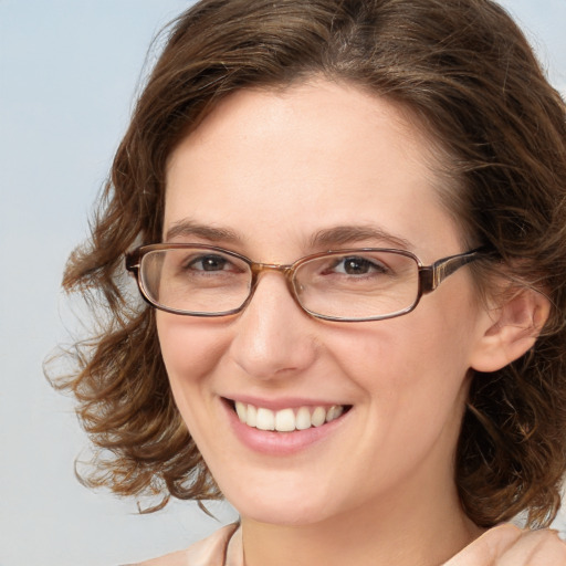 Joyful white young-adult female with medium  brown hair and blue eyes