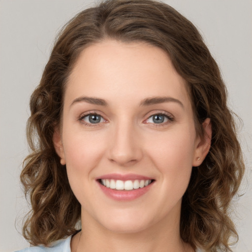 Joyful white young-adult female with long  brown hair and green eyes