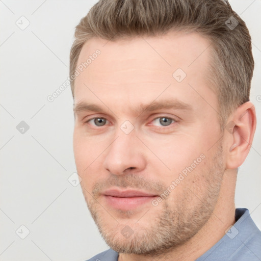 Joyful white adult male with short  brown hair and grey eyes