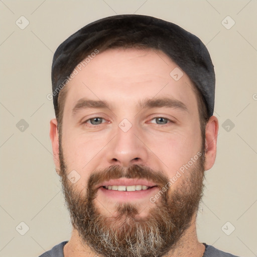 Joyful white young-adult male with short  black hair and brown eyes