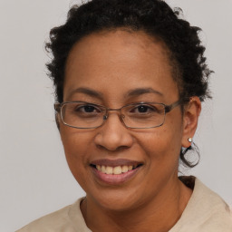 Joyful black adult female with short  brown hair and brown eyes