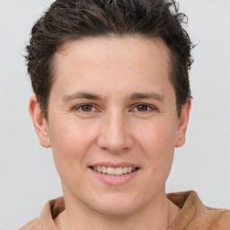 Joyful white young-adult male with short  brown hair and grey eyes