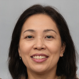 Joyful white adult female with long  brown hair and brown eyes