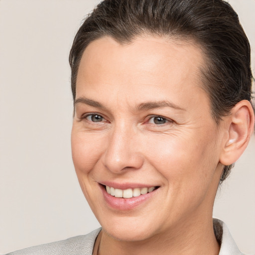 Joyful white adult female with short  brown hair and brown eyes