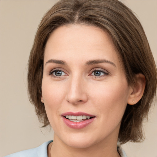 Joyful white young-adult female with medium  brown hair and green eyes