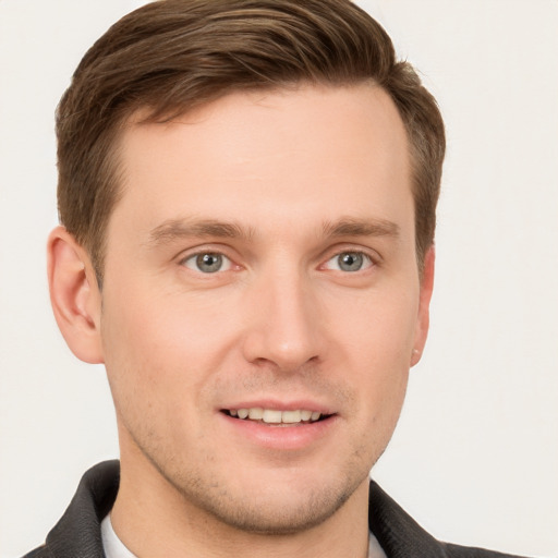 Joyful white young-adult male with short  brown hair and grey eyes