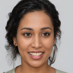 Joyful latino young-adult female with medium  brown hair and brown eyes