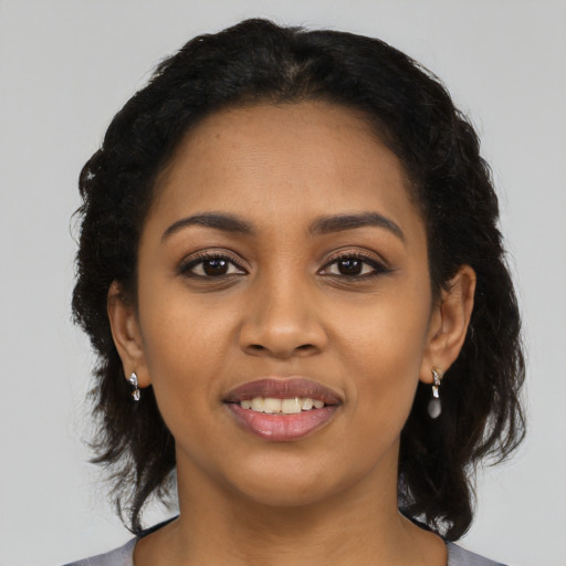 Joyful latino young-adult female with medium  black hair and brown eyes