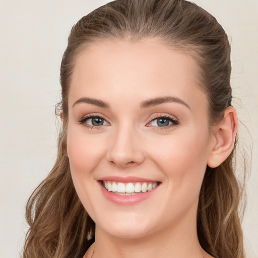 Joyful white young-adult female with long  brown hair and green eyes