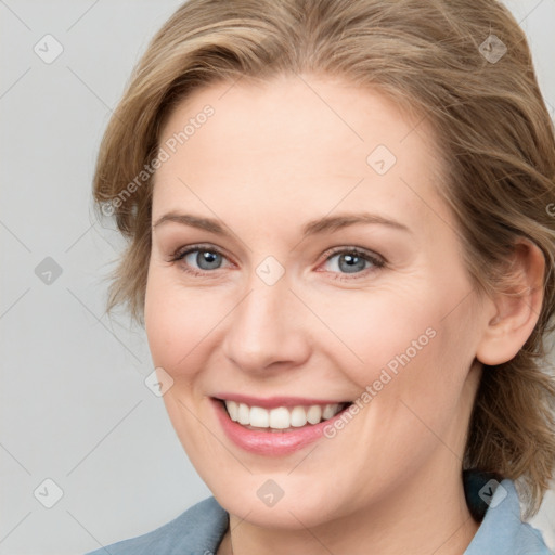 Joyful white young-adult female with medium  brown hair and blue eyes