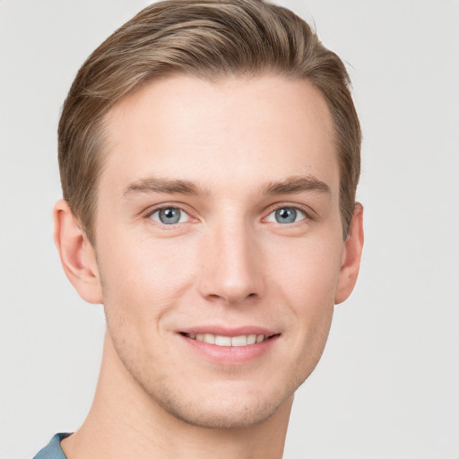 Joyful white young-adult male with short  brown hair and grey eyes