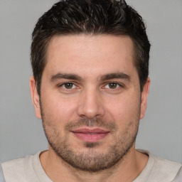 Joyful white young-adult male with short  brown hair and brown eyes