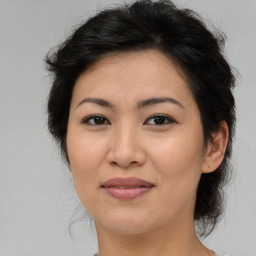 Joyful asian adult female with medium  brown hair and brown eyes