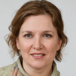 Joyful white adult female with medium  brown hair and grey eyes