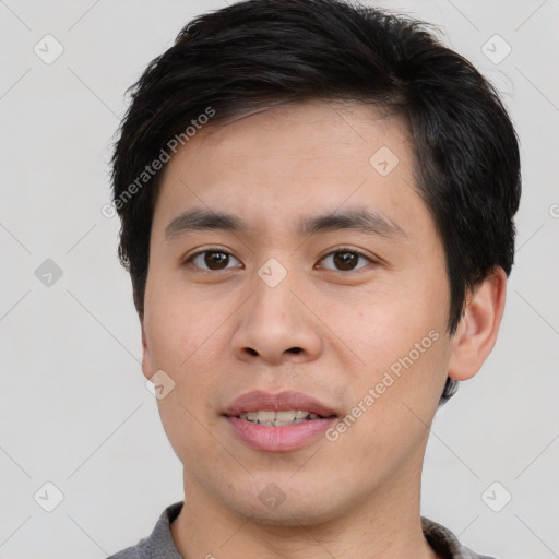 Joyful asian young-adult male with short  black hair and brown eyes