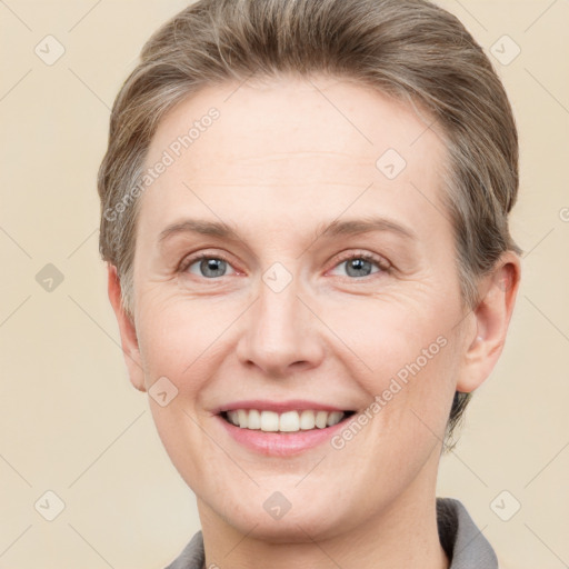 Joyful white adult female with short  brown hair and grey eyes