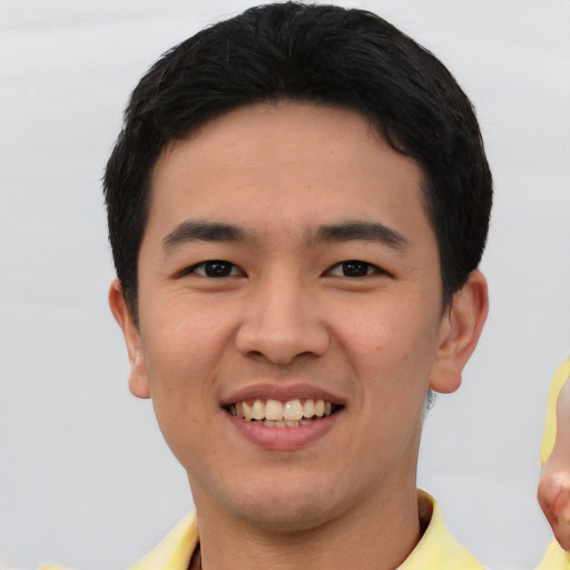 Joyful white young-adult male with short  black hair and brown eyes
