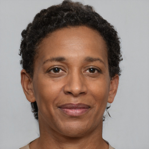 Joyful black adult female with short  brown hair and brown eyes