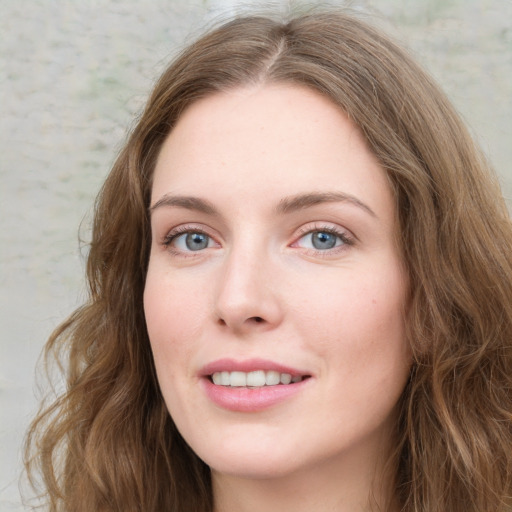 Joyful white young-adult female with long  brown hair and green eyes