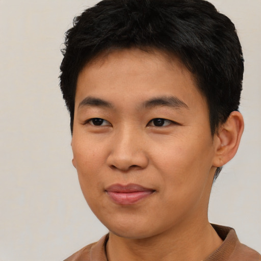 Joyful asian young-adult male with short  black hair and brown eyes