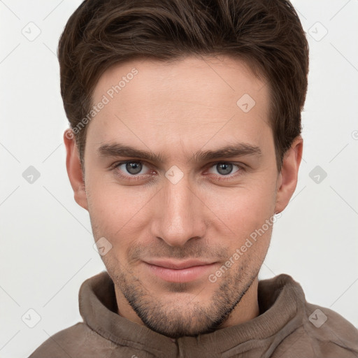 Joyful white young-adult male with short  brown hair and grey eyes