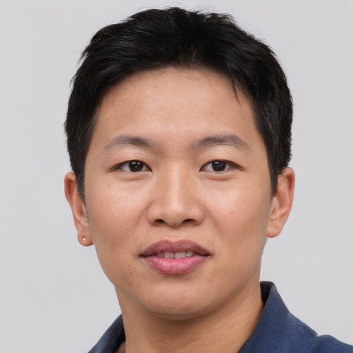 Joyful asian young-adult male with short  black hair and brown eyes
