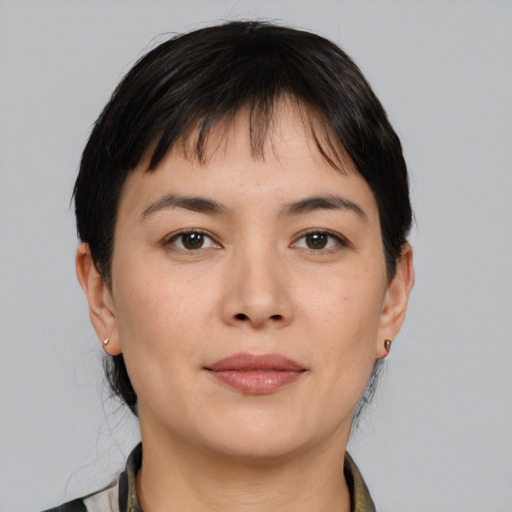 Joyful asian young-adult female with medium  brown hair and brown eyes