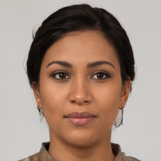 Joyful latino young-adult female with medium  brown hair and brown eyes