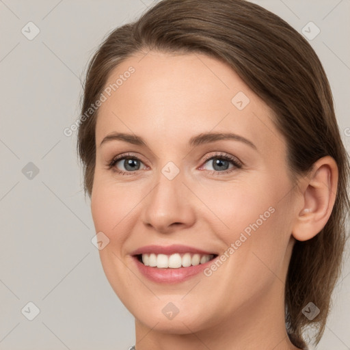 Joyful white young-adult female with medium  brown hair and grey eyes