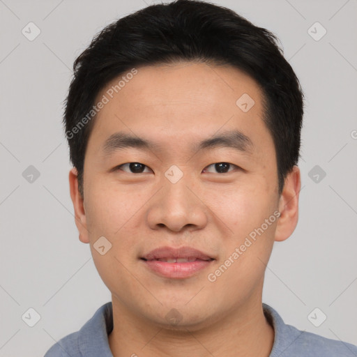 Joyful asian young-adult male with short  black hair and brown eyes