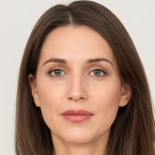 Joyful white adult female with long  brown hair and brown eyes