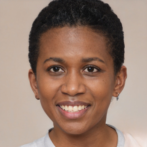Joyful black young-adult female with short  black hair and brown eyes