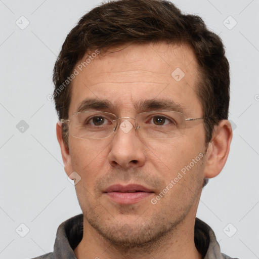 Joyful white adult male with short  brown hair and brown eyes