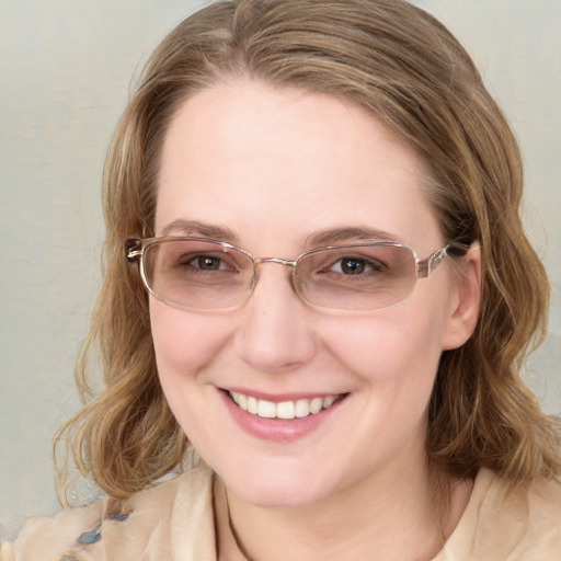 Joyful white young-adult female with long  brown hair and blue eyes