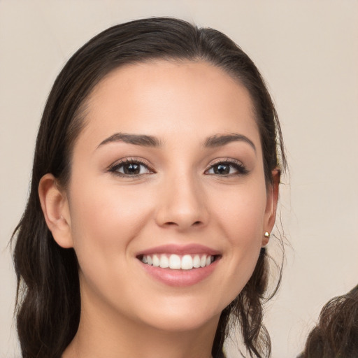 Joyful white young-adult female with long  brown hair and brown eyes