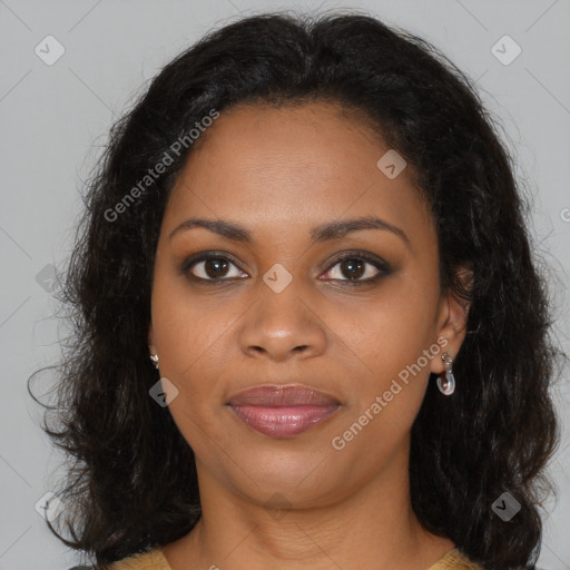 Joyful black young-adult female with long  brown hair and brown eyes