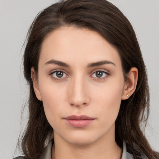 Neutral white young-adult female with long  brown hair and brown eyes