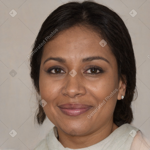 Joyful black adult female with medium  brown hair and brown eyes