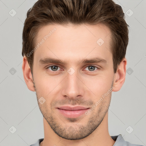 Joyful white young-adult male with short  brown hair and grey eyes