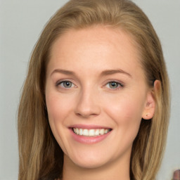 Joyful white young-adult female with long  brown hair and blue eyes