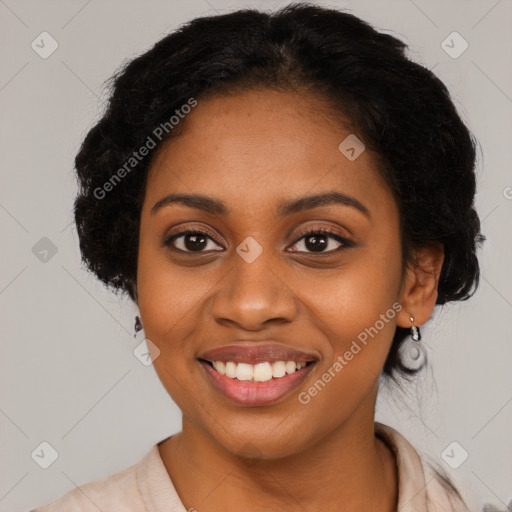 Joyful black young-adult female with long  black hair and brown eyes