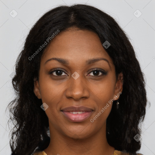 Joyful black young-adult female with long  brown hair and brown eyes