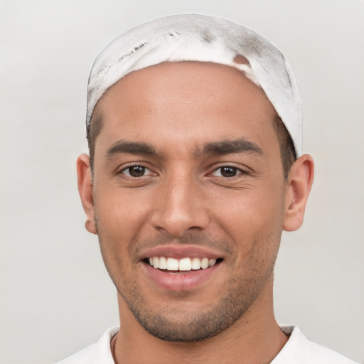 Joyful white young-adult male with short  black hair and brown eyes