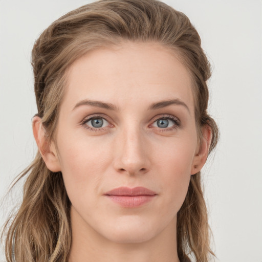 Joyful white young-adult female with long  brown hair and blue eyes