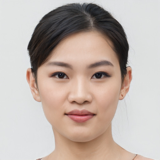 Joyful asian young-adult female with medium  black hair and brown eyes