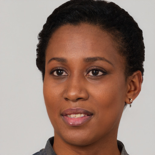 Joyful black young-adult female with short  brown hair and brown eyes
