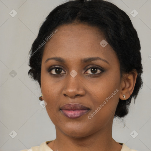 Joyful black young-adult female with short  black hair and brown eyes